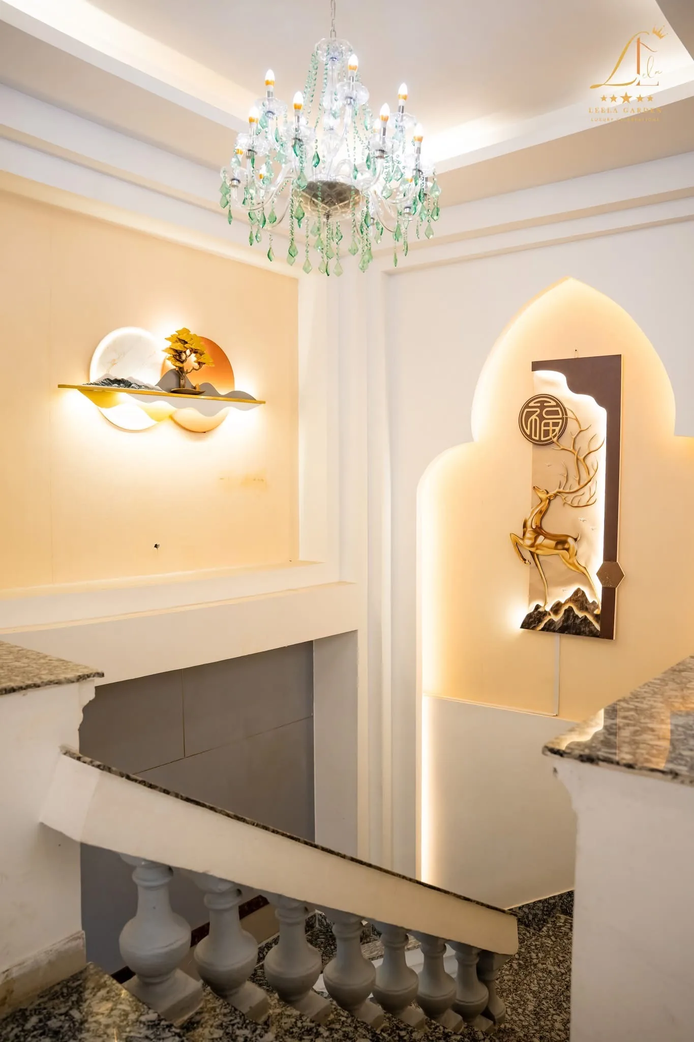 A backlit wall niche holding a gilded sculptural panel, set into pale stone.